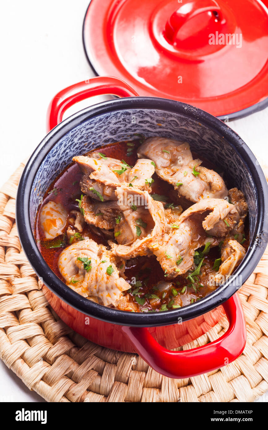 Stewed chicken gizzards in red pan on the mat Stock Photo Alamy
