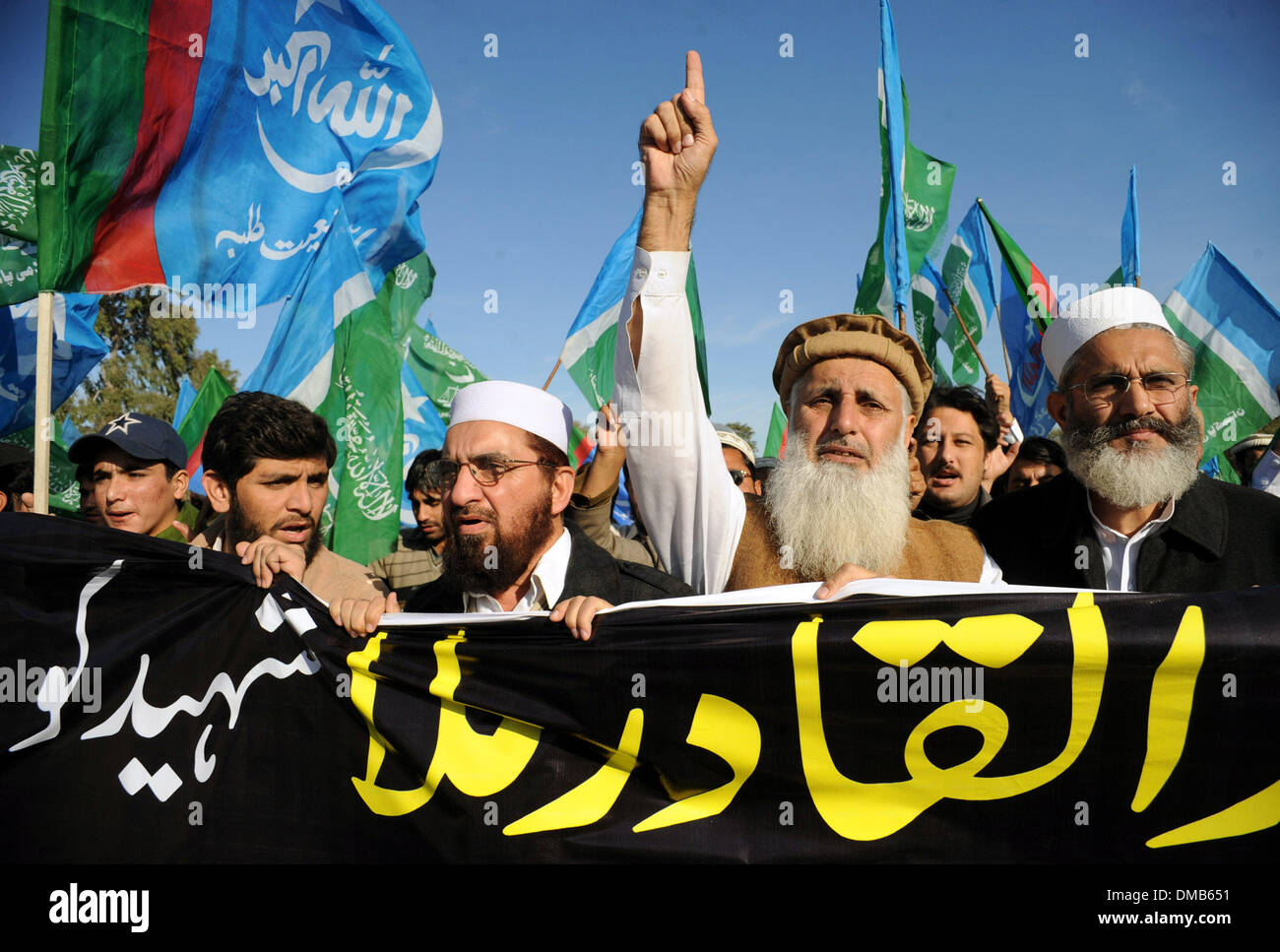 Peshawar, Pakistan. 13th Dec, 2013. Activists of the Jamaat-e-Islami party shout slogans for Bangladeshi Islamist leader Abdul Quader Molla a day after his execution, in northwest Pakistan' s Peshawar on Dec. 13, 2013. Bangladesh has executed Abdul Quader Molla, an Islamist party leader convicted of war crimes in 1971, which is the first execution of a war criminal in the country. In protest against Molla's execution, his party Jamaat called countrywide dawn-to-dusk general strike for Sunday. Credit:  Ahmad Sidique/Xinhua/Alamy Live News Stock Photo