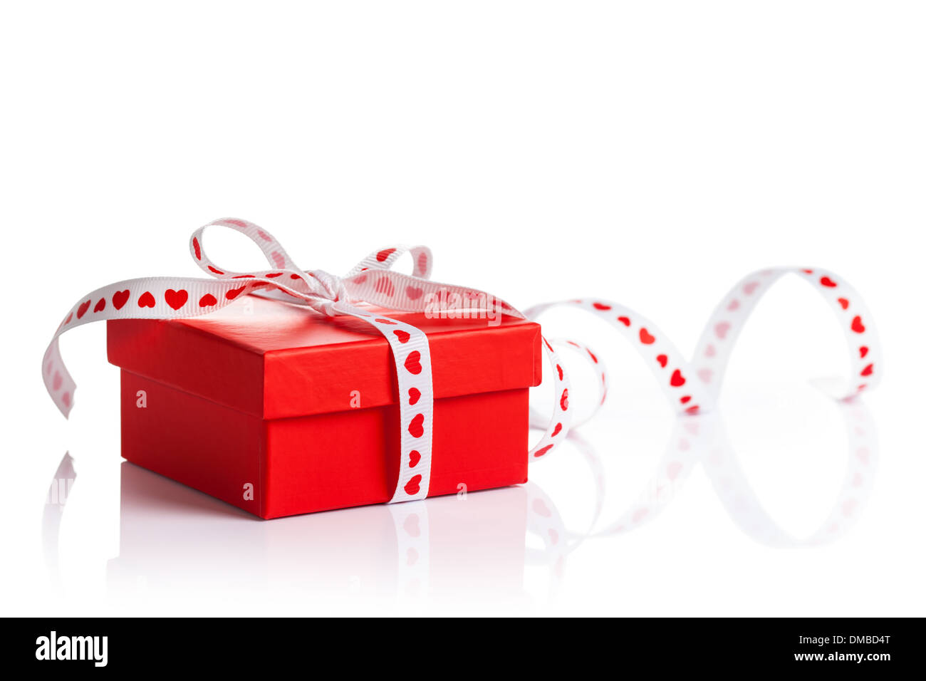 Red gift box with ribbon on white background Stock Photo - Alamy
