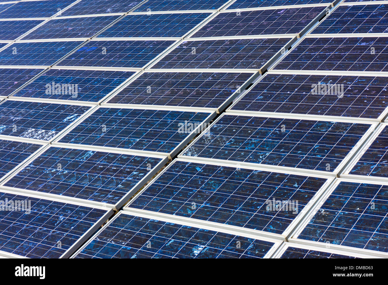 Blue photo-voltaic solar panels against a blue sky Stock Photo