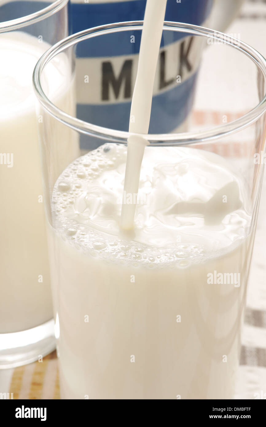 Pouring a glass of fresh milk Stock Photo