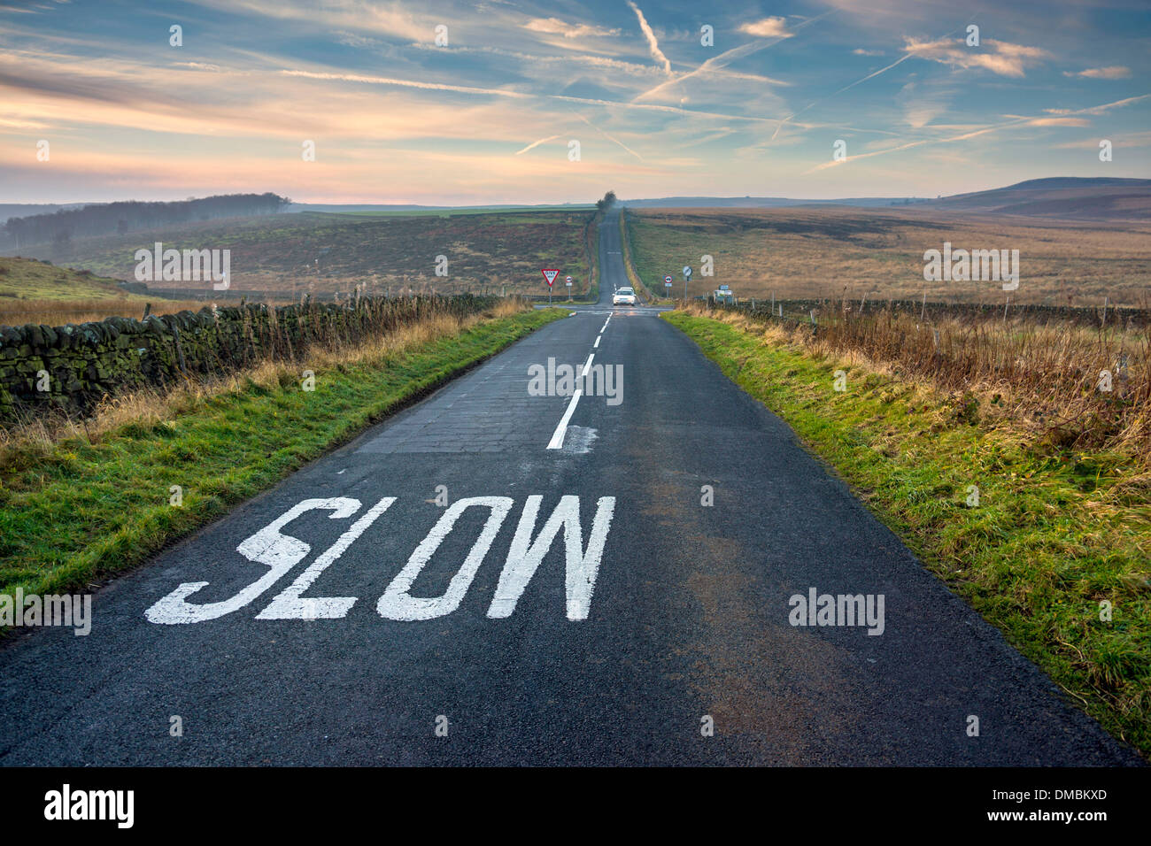 Road with slow sign perspective, distance, vanishing point Stock Photo