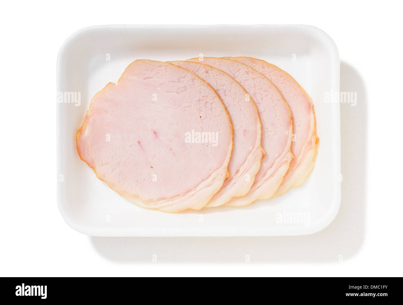 Four slices of fat roll ham with rind in a foam tray, isolated on white ...