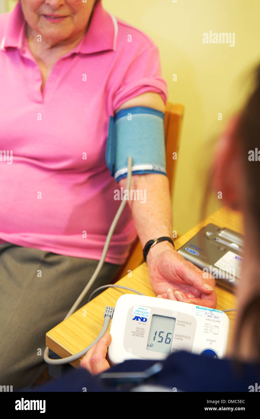 Nurse checking patients blood pressure during clinic in GP Surgery