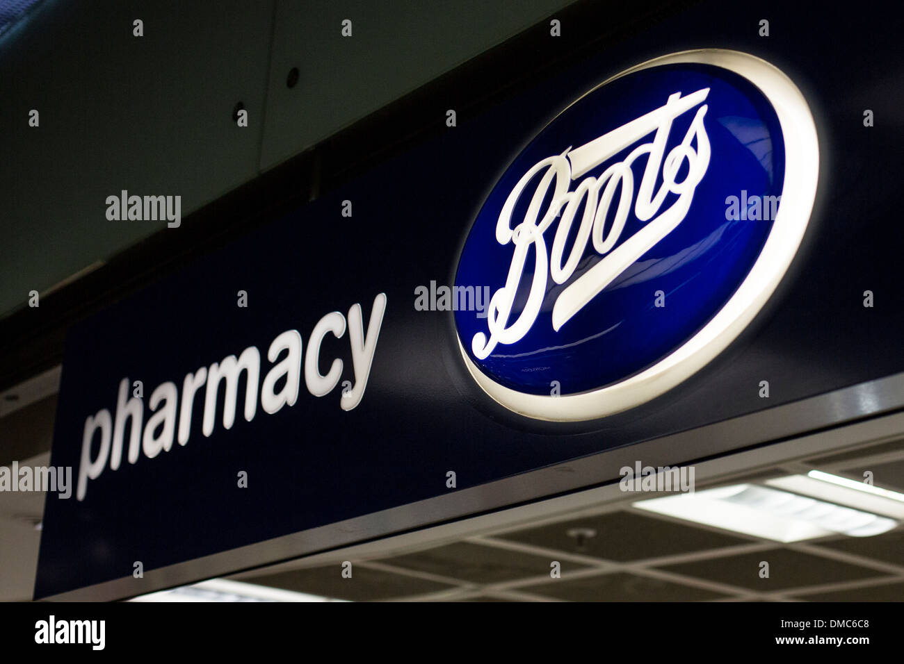 Boots logo and pharmacy sign above store entrance Stock Photo - Alamy