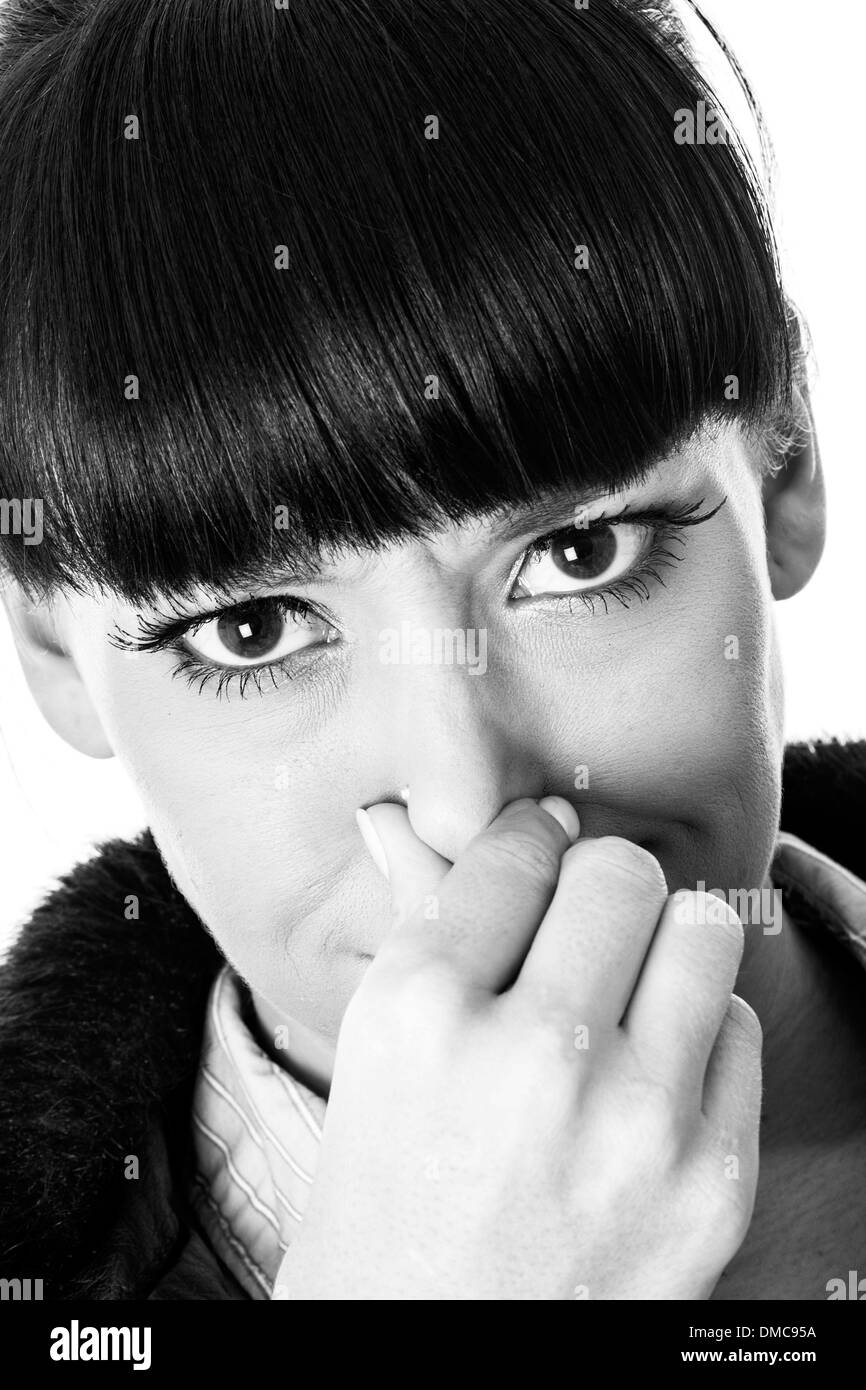 Attractive Young Woman Pinching Her Nose Stock Photo Alamy