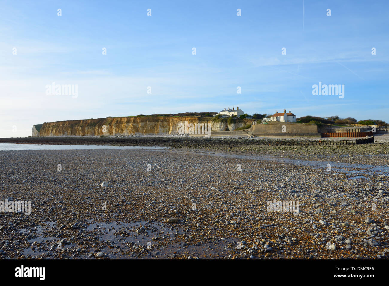 The cliffs of Seaford Head and Coastguard cottages at low tide at Cuckmere Haven, East Sussex, UK Stock Photo