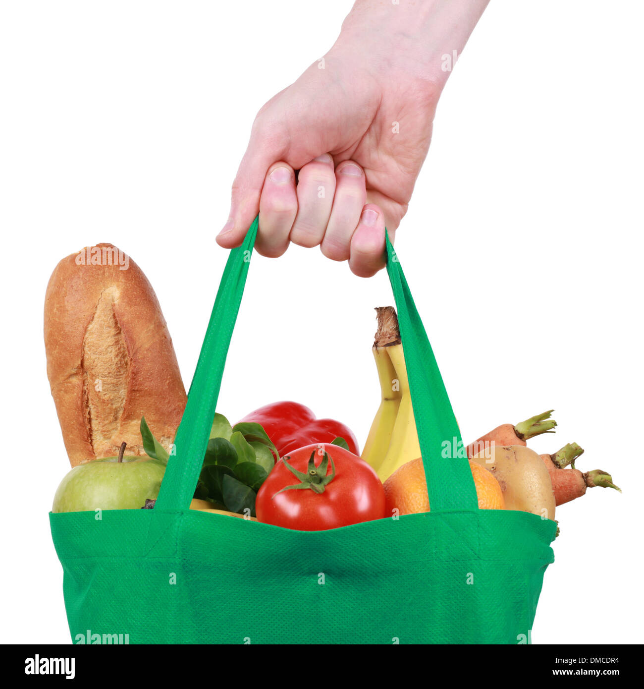 Hand holding a reusable shopping bag filled with fruits and vegetables