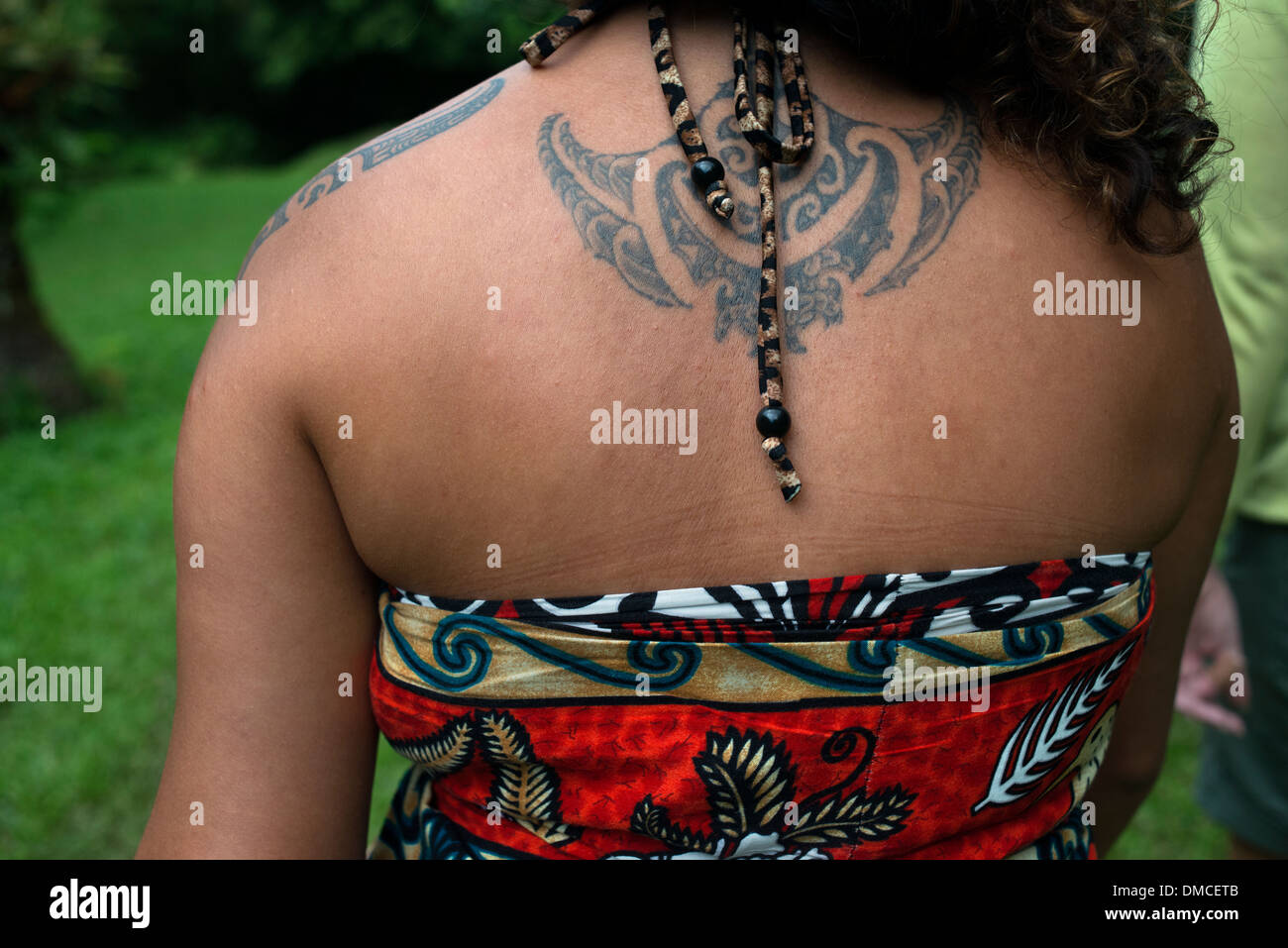 Rarotonga Island. Cook Island. Polynesia. South Pacific Ocean. A woman showing her back in a typical Polynesian or maorí tattoo. Stock Photo