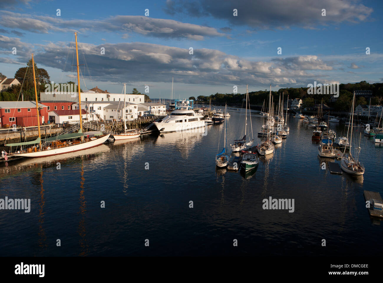 sailboats and powerboats tied up in the inner harbor of Camden Maine. Wayfarer Marine is in the background. Stock Photo