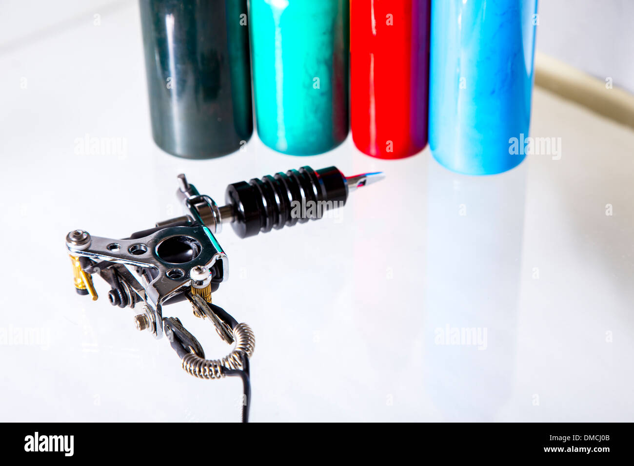 Tattoo gun with ink tubes on white background Stock Photo Alamy