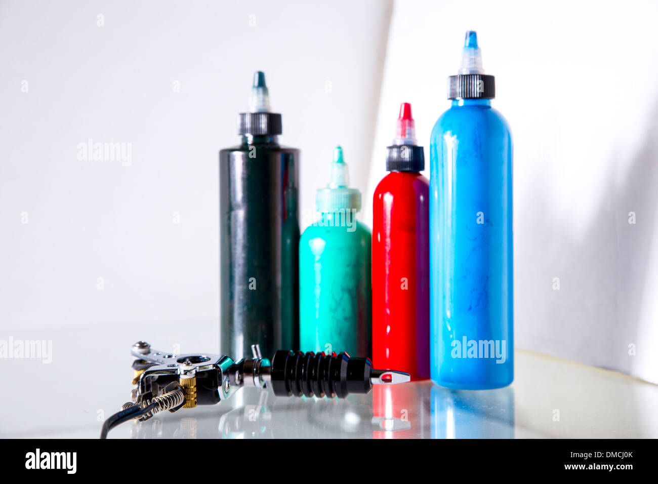 Tattoo gun with ink tubes on white background Stock Photo Alamy