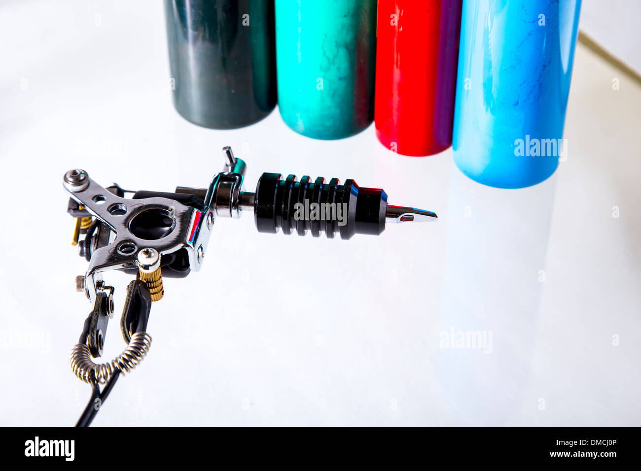 Tattoo gun with ink tubes on white background Stock Photo Alamy