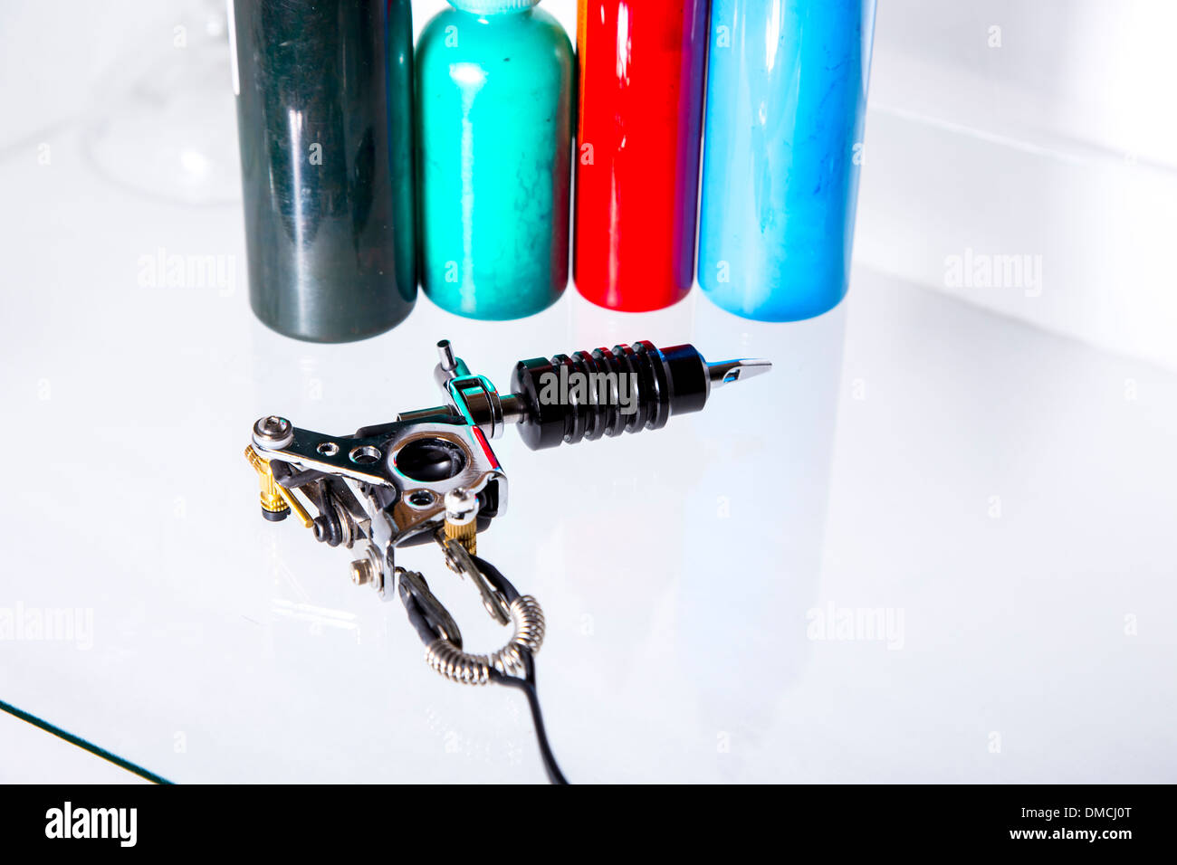 Tattoo gun with ink tubes on white background Stock Photo Alamy
