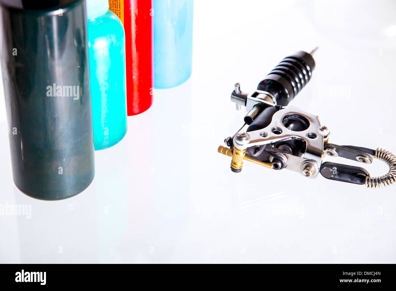 Tattoo gun with ink tubes on white background Stock Photo Alamy