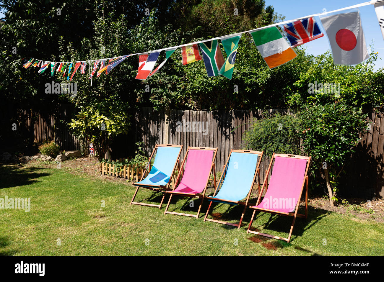 Multinational flags on a string at a garden party. Stock Photo