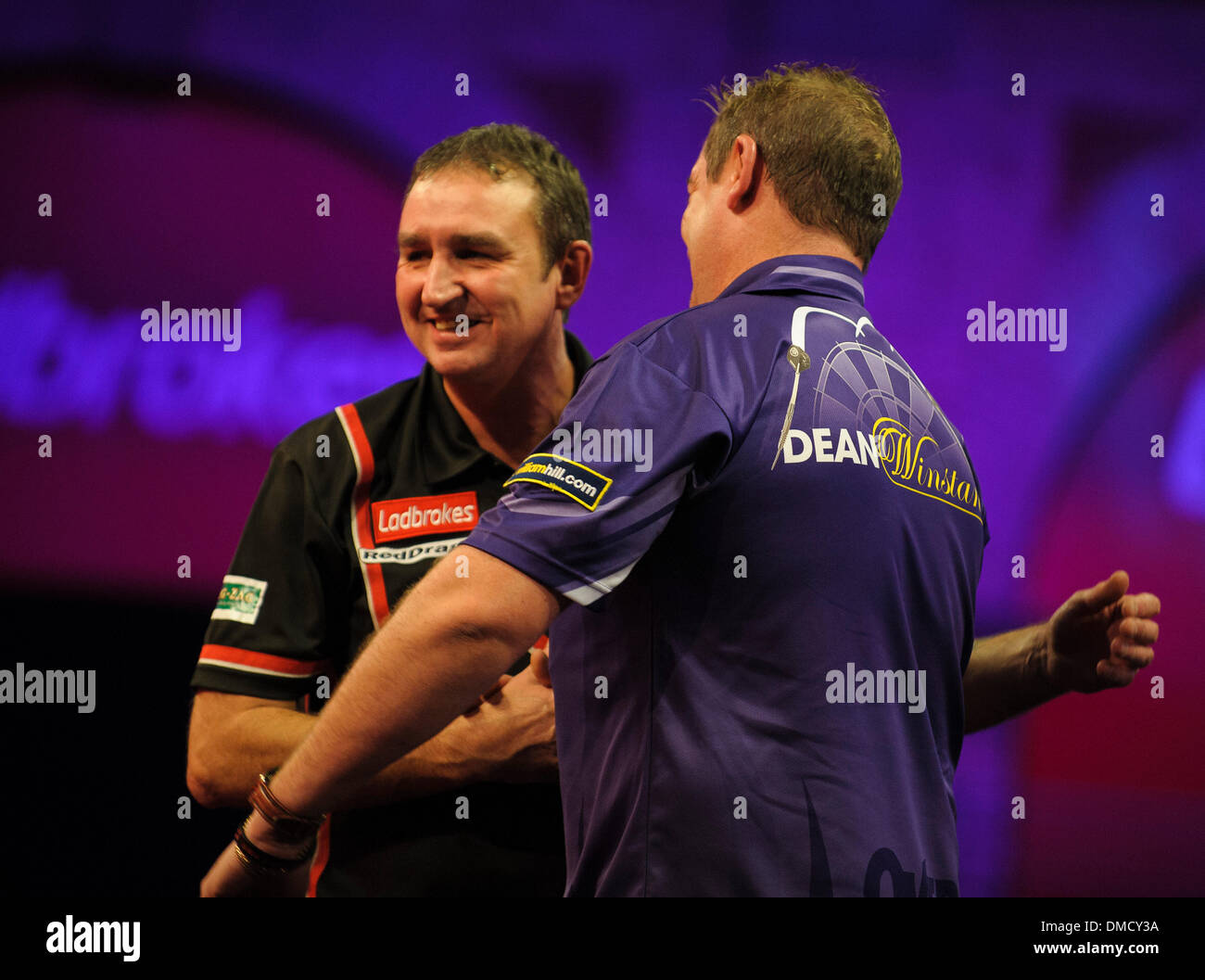 London, UK. 13th Dec, 2013. Richie Burnett (Wales) [28] in congratulated by Dean Winstanley (England) in their first round match at The Ladbrokes World Darts Championships from Alexandra Palace. Credit:  Action Plus Sports/Alamy Live News Stock Photo