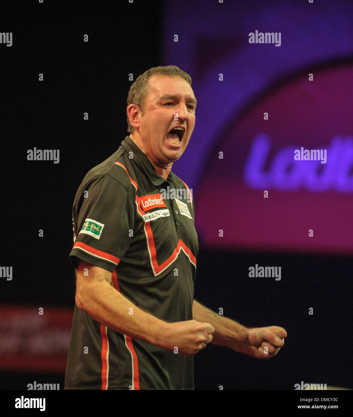 London, UK. 13th Dec, 2013. Richie Burnett (Wales) [28] celebrates his win over Dean Winstanley (England) in their first round match at The Ladbrokes World Darts Championships from Alexandra Palace. Credit:  Action Plus Sports/Alamy Live News Stock Photo