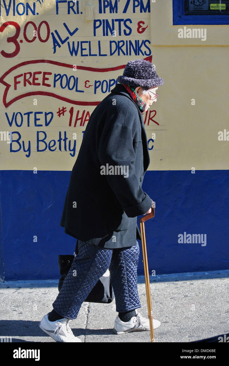 senior citizen walk along sidewalk with cane in North Beach california