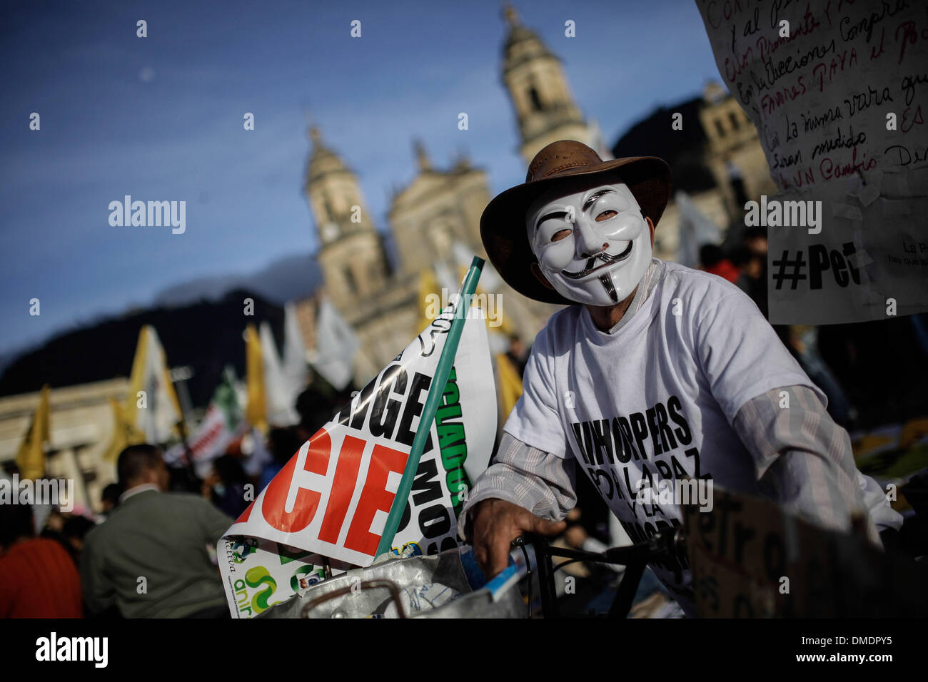 Bogota, Colombia. 13th Dec, 2013. A demonstrator participates in the 'March for Peace and Democracy' during the fifth day of protests against the destitution of Bogota's Mayor Gustavo Petro at Bolivar's Square in the city of Bogota, capital of Colombia, on Dec. 13, 2013. Mayor of Colombian capital of Bogota was removed from post on Monday and barred from holding office for 15 years over mismanagement in the garbage collection scheme in the city last year. Credit:  Jhon Paz/Xinhua/Alamy Live News Stock Photo