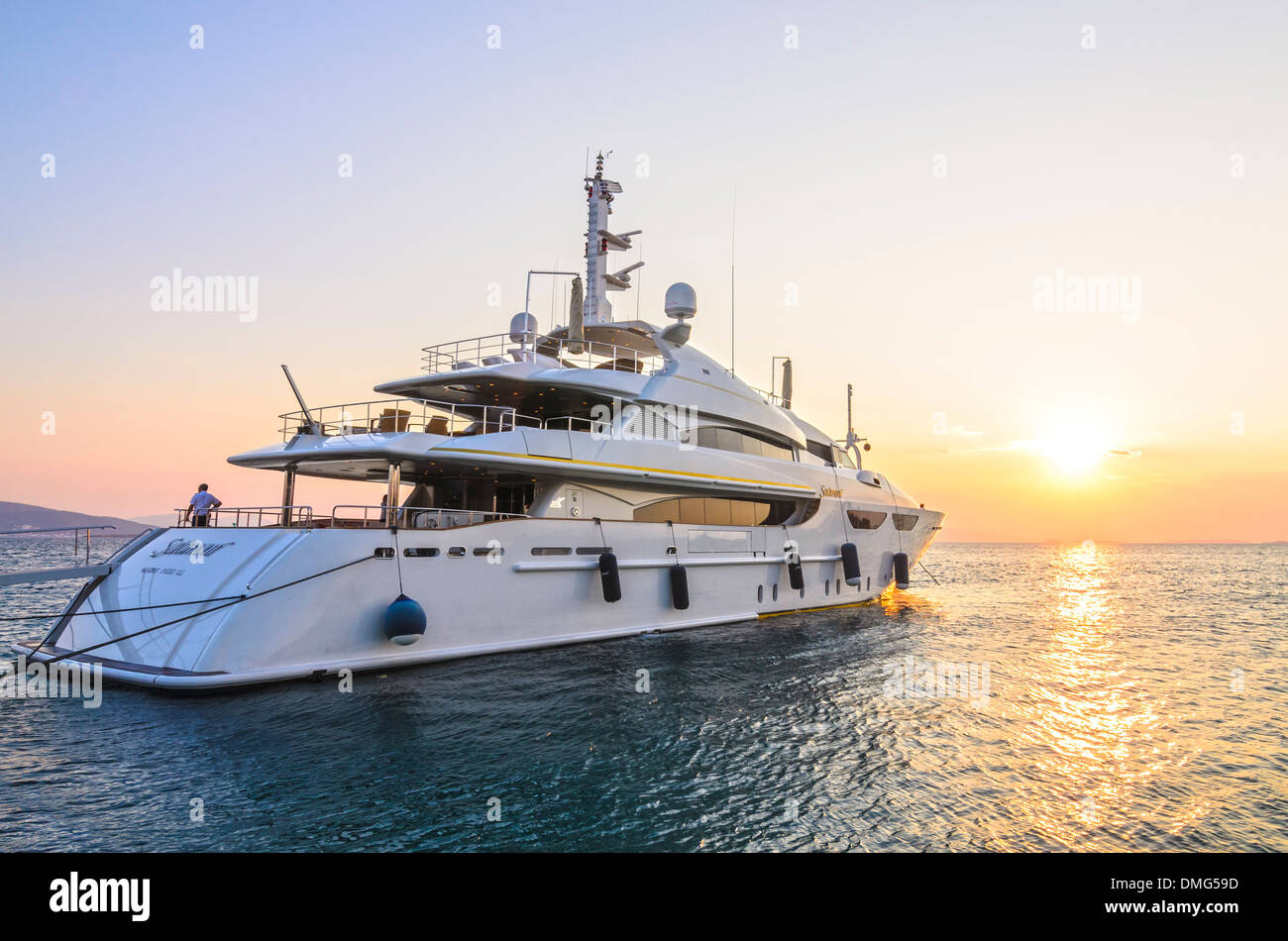 The 46m luxury motor yacht Saramour anchored in Aegina Town at sunset, Aegina Island, Greece Stock Photo