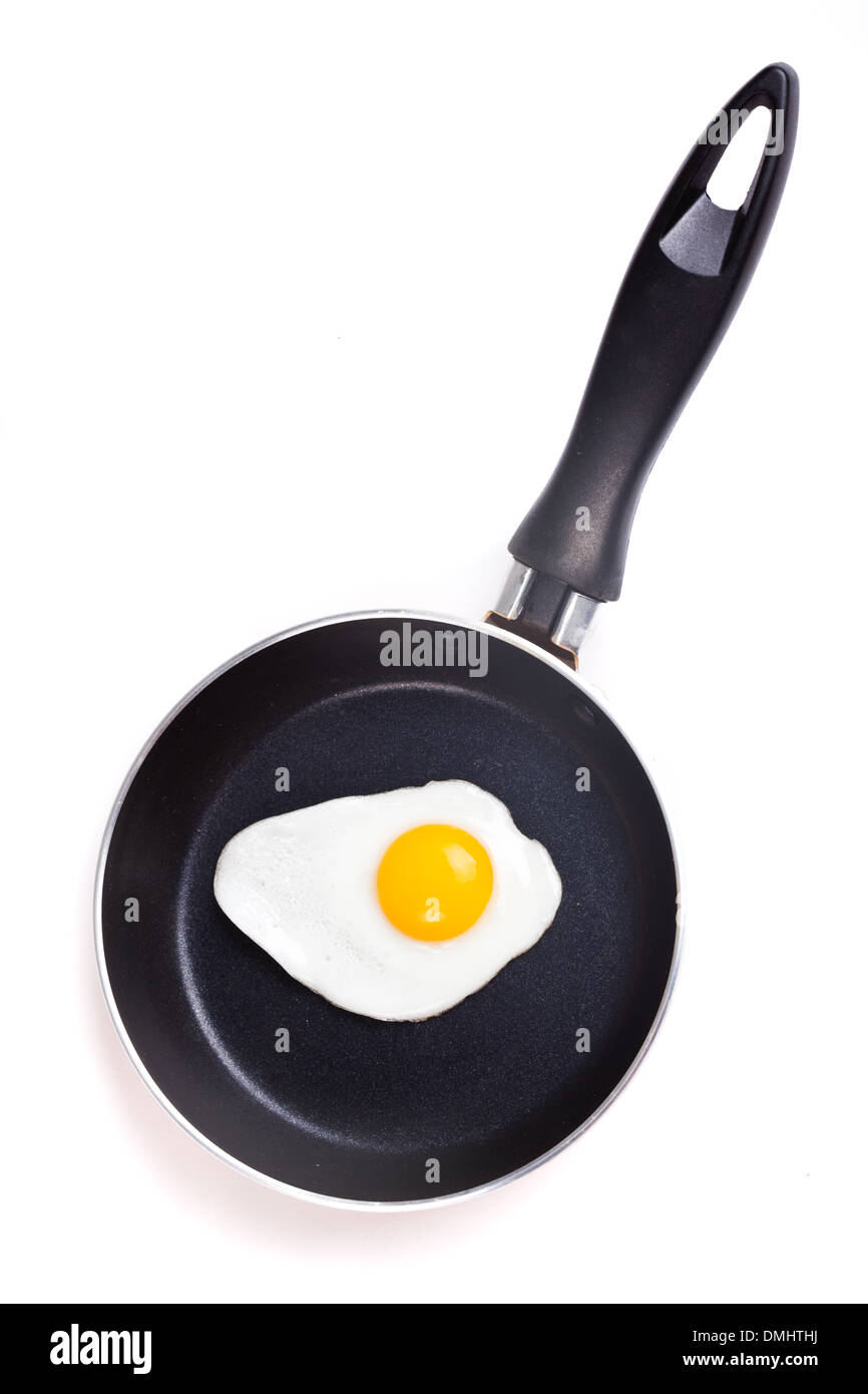 One fried egg on teflon pan without oil isolated on white Stock Photo