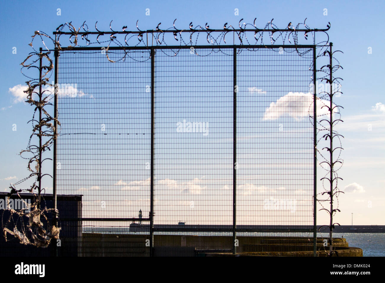 Metal fence at the Port of Dover Ferry Terminal secured with razor wire. Dover, UK Stock Photo