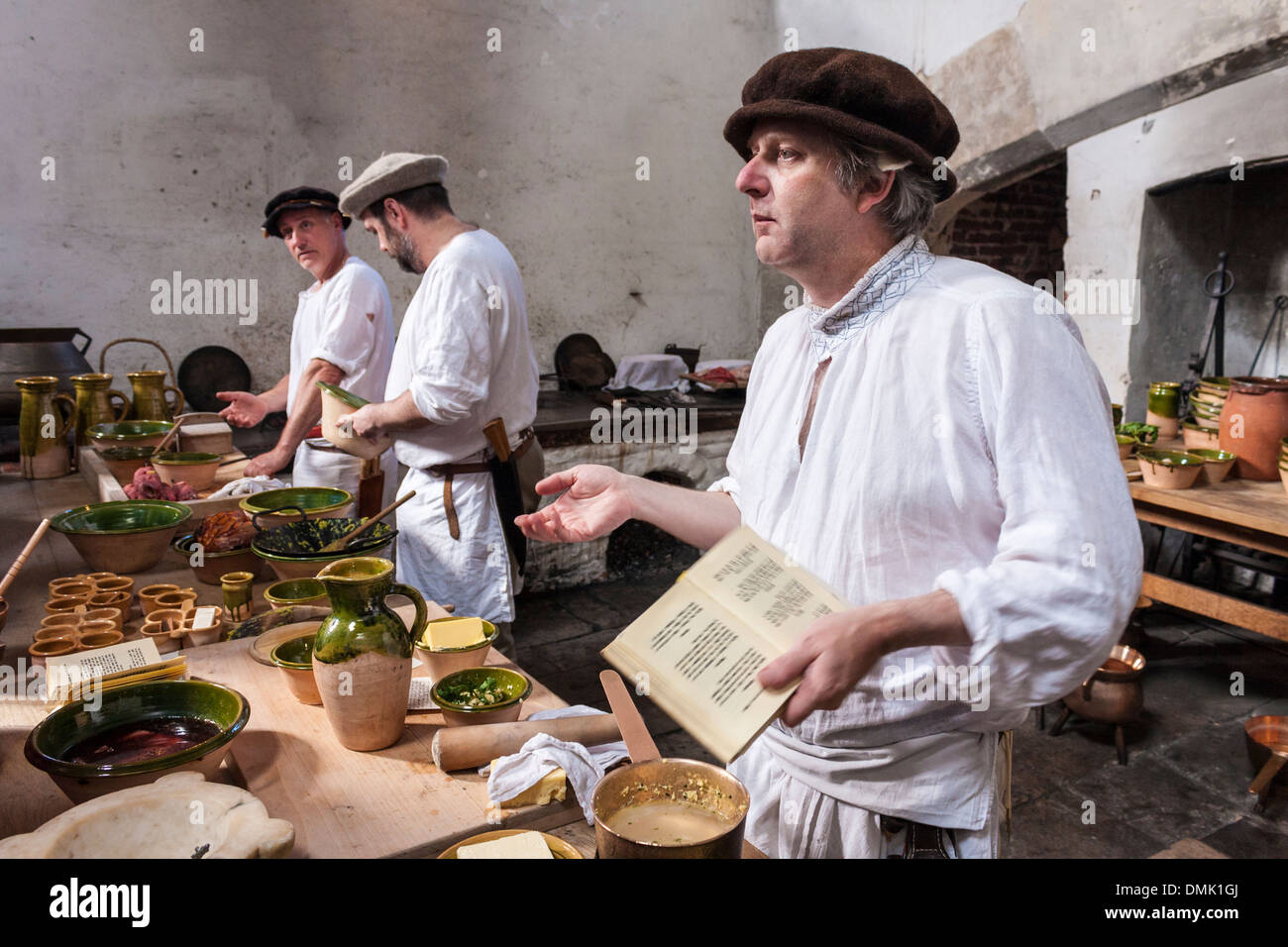 Cooks prepare traditional dishes from historical recipes in the Tudor kitchens at Hampton Court Palace, London, England, GB, UK. Stock Photo
