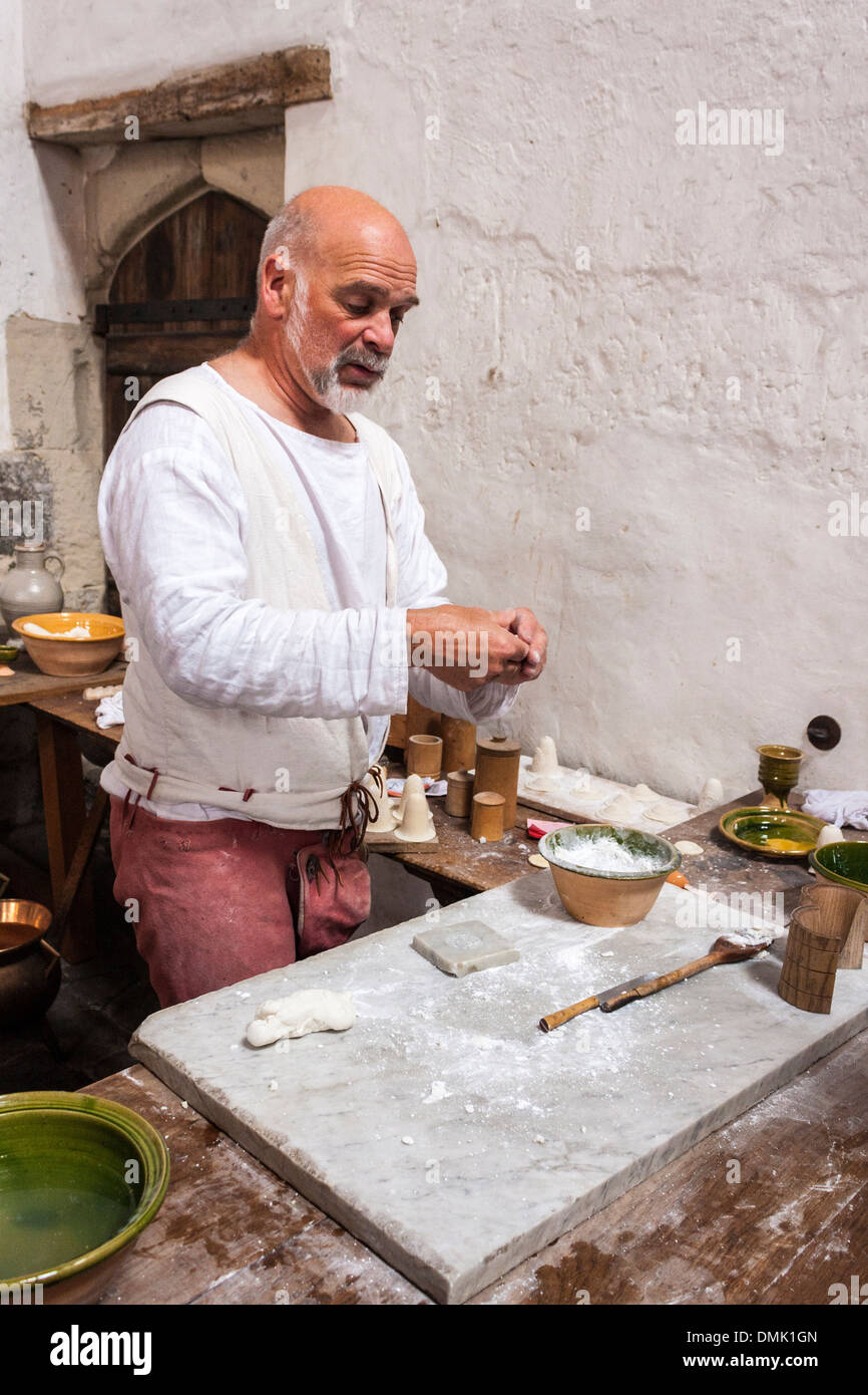 Cooks prepare traditional dishes from historical recipes in the Tudor kitchens at Hampton Court Palace, London, England, GB, UK. Stock Photo