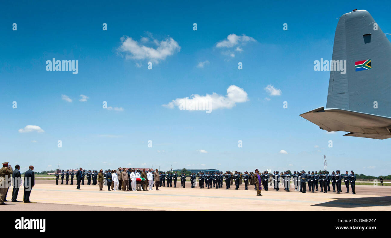 PRETORIA, SOUTH AFRICA: SANDF officials carry Nelson Mandela's coffin at the Waterkloof Air Base  on December 14, 2013 in Pretoria, South Africa. World icon, Nelson Mandela passed away quietly on the evening of December 5, 2013 at his home in Houghton with family. Tata will be laid to rest at his homestead tomorrow. (Photo by Gallo Images / Foto24 / Theana Beuregem) Stock Photo