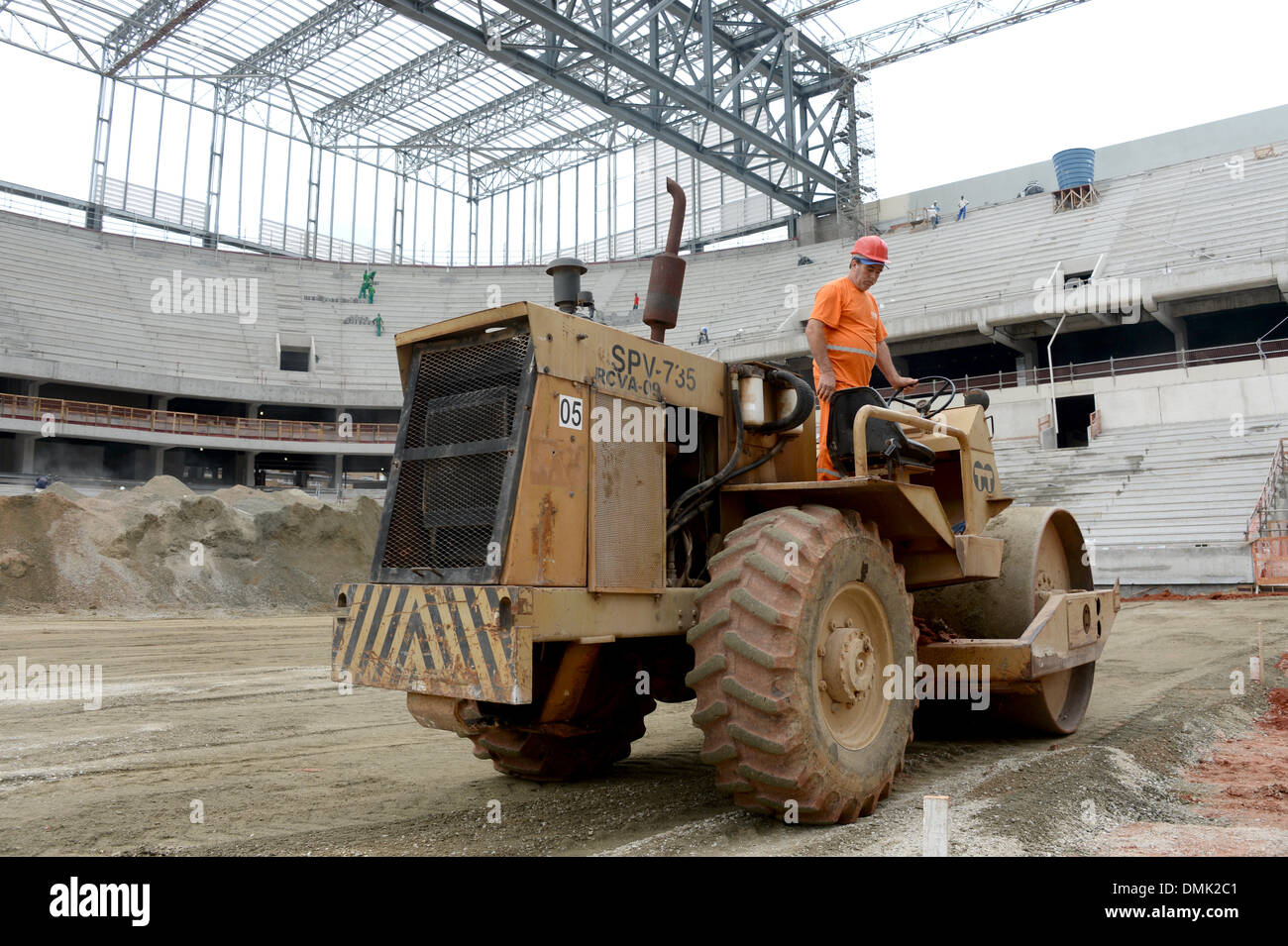 A construction worker drives in the stadium 'Arena da Baixada' in Curitiba, Brazil, 14 December 2013. The Arena de Baixada is one of the stadiums for the FIFA World Cup 2014 in Brazil. Photo: Marcus Brandt/dpa Stock Photo