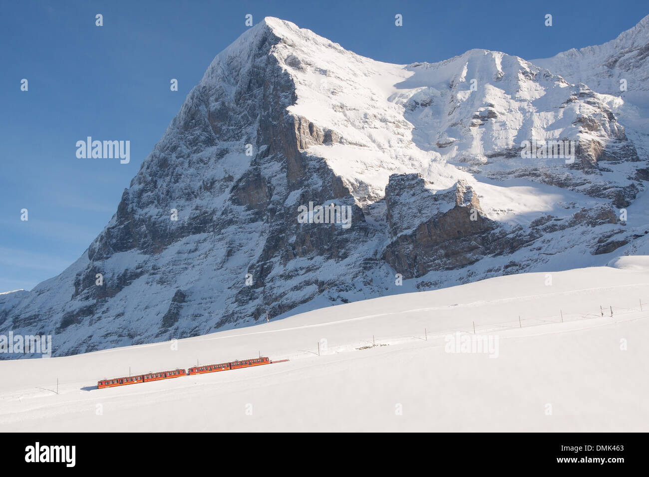 WINTRY VIEW OF THE TRAIN OF THE JUNGFRAU MAKING ITS WAY THROUGH THE SNOW AT THE SUMMIT OF THE EIGER, BERNESE ALPS IN WINTER, CANTON OF BERN, SWITZERLAND Stock Photo