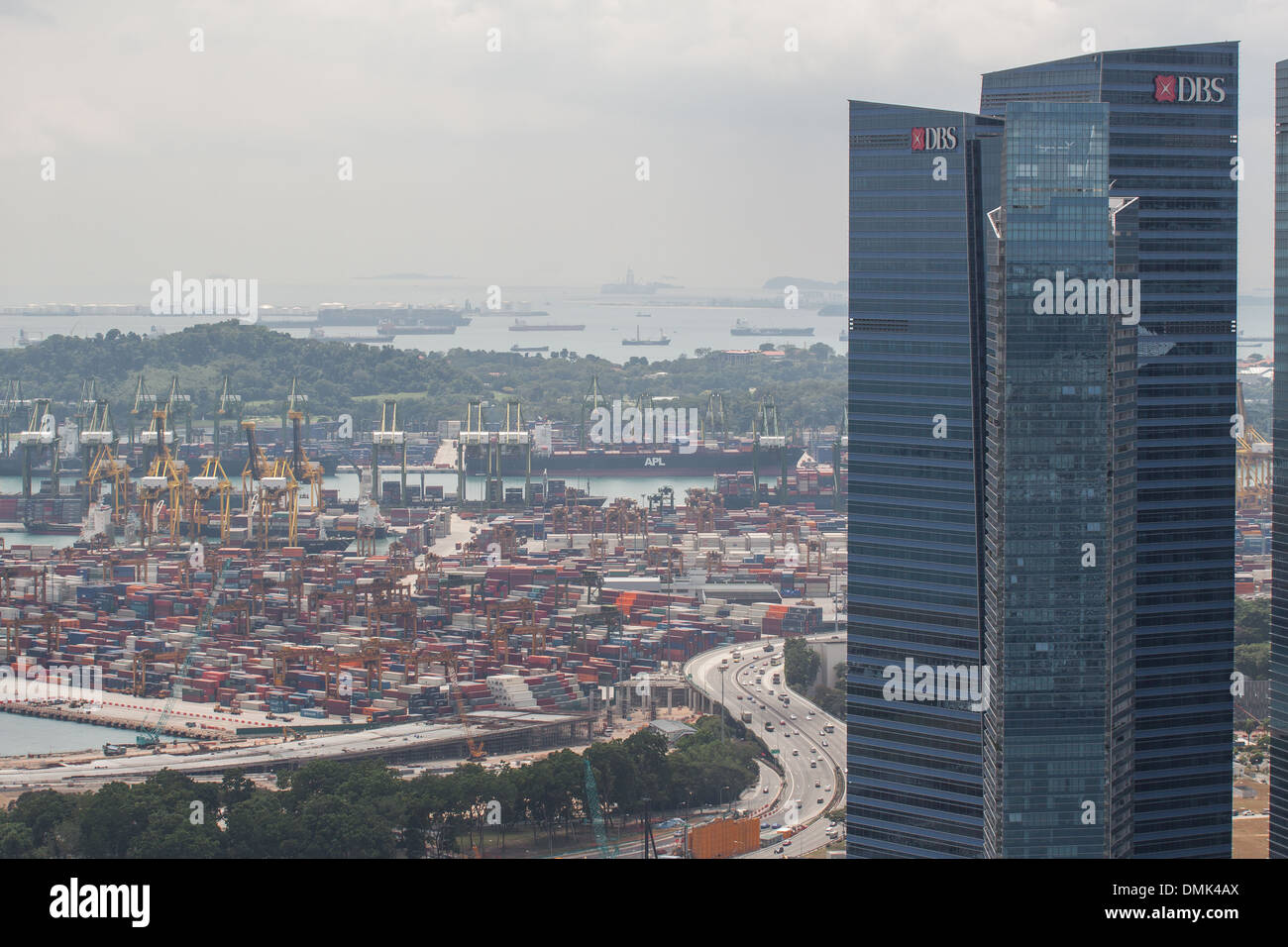 VIEW FROM THE TERRACE OF THE HOTEL MARINA BAY SANDS OF A BUILDING IN THE FINANCIAL DISTRICT AND, IN THE DISTANCE, THE COMMERCIAL PORT OF SINGAPORE, MARINA BAY, CENTRAL BUSINESS DISTRICT, SINGAPORE Stock Photo