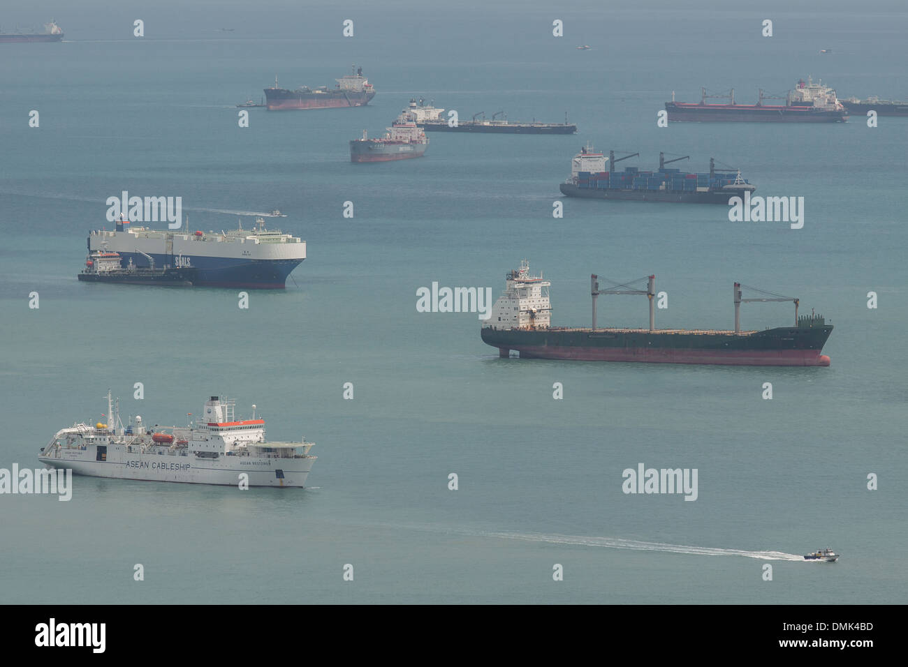 CARGO BOATS, TANKERS AND CONTAINER SHIPS OFF THE PORT OF SINGAPORE Stock Photo