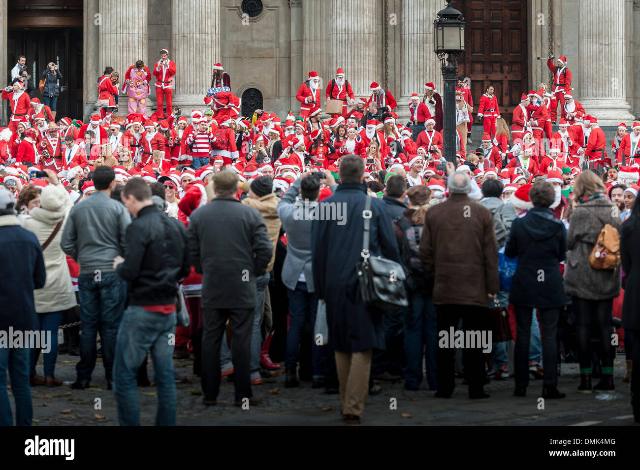 London, UK. 14th December, 2013.  Hundreds of Santas gathering on the steps of St Pauls Cathedral before they march off to meet up with groups of other Santas to celebrate the annual Santacon.  Photographer: Gordon Scammell/Alamy Live News Stock Photo