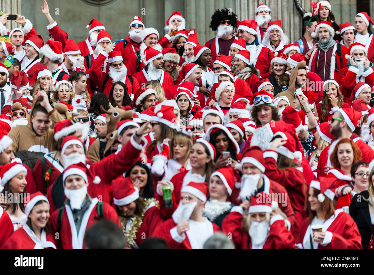 London, UK. 14th December, 2013.  Hundreds of Santas gather on the steps of St Pauls Cathedral before they march off to meet up with groups of other Santas to celebrate the annual Santacon.  Photographer: Gordon Scammell/Alamy Live News Stock Photo