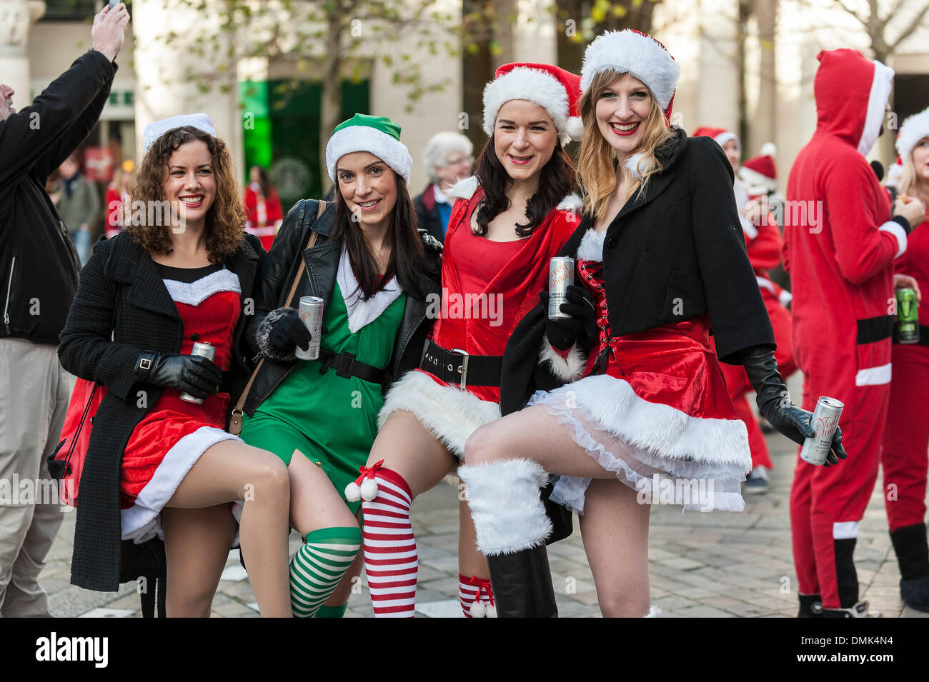 London, UK. 14th December, 2013.  Four girls having fun at this year's Santacon.  Hundreds of Santas gather on the steps of St Pauls Cathedral before they march off to meet up with groups of other Santas to celebrate the annual Santacon.  Photographer: Gordon Scammell/Alamy Live News Stock Photo