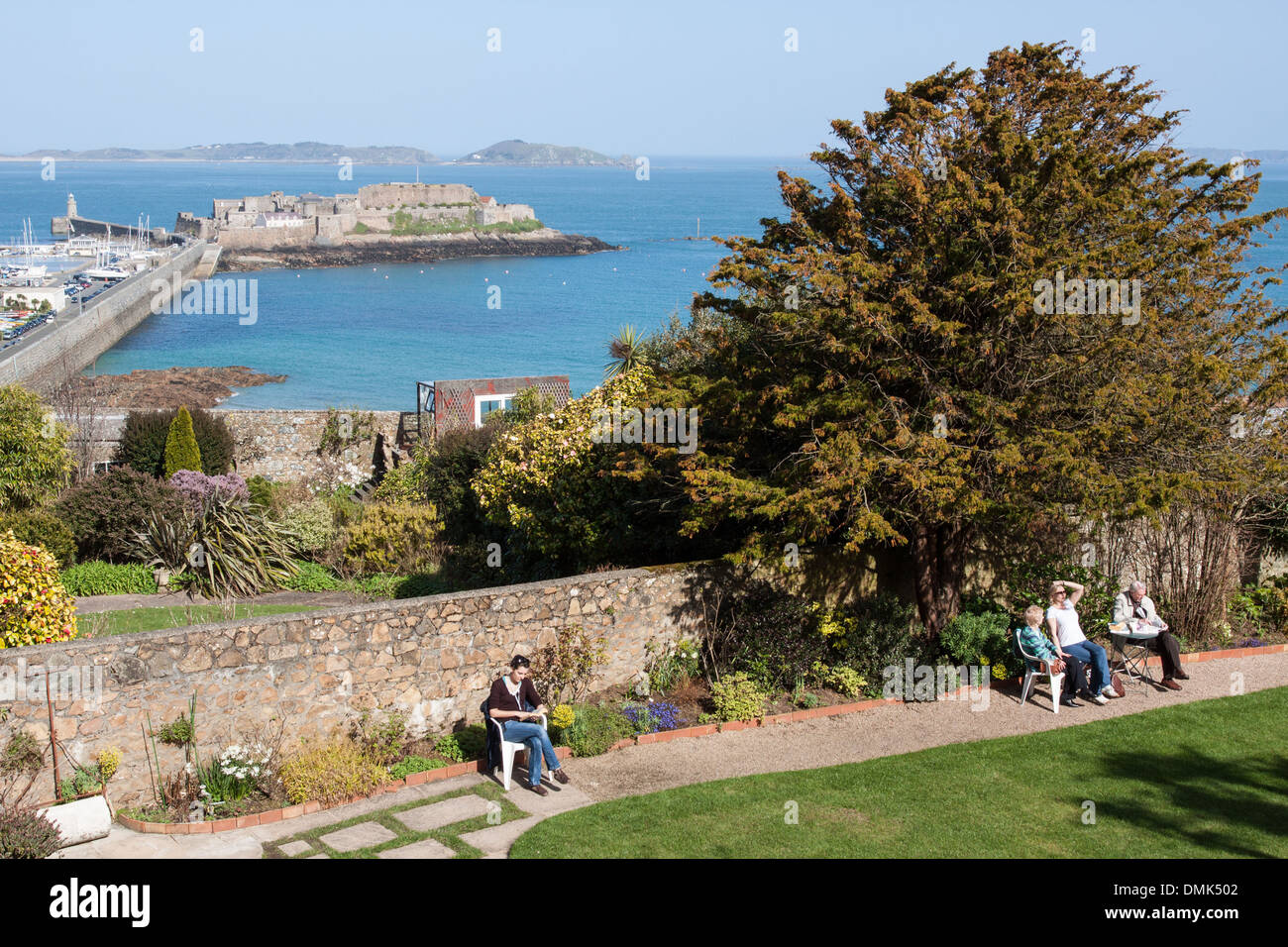 VIEW OF THE GARDEN AT HAUTEVILLE HOUSE, VICTOR HUGO'S HOUSE, WITH CASTLE CORNET AND HERM ISLAND IN THE BACKGROUND, SAINT PETER PORT, GUERNSEY, CHANNEL ISLANDS Stock Photo