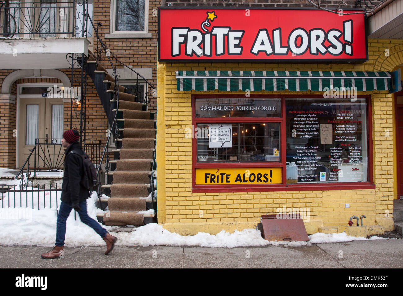 PASSER-BY IN FRONT OF THE RESTAURANT FRITE, A BELGIAN POMME FRITES SHOP REVISITED BY THE QUEBECOIS, THE PLATEAU QUARTER, MONTREAL, QUEBEC, CANADA Stock Photo