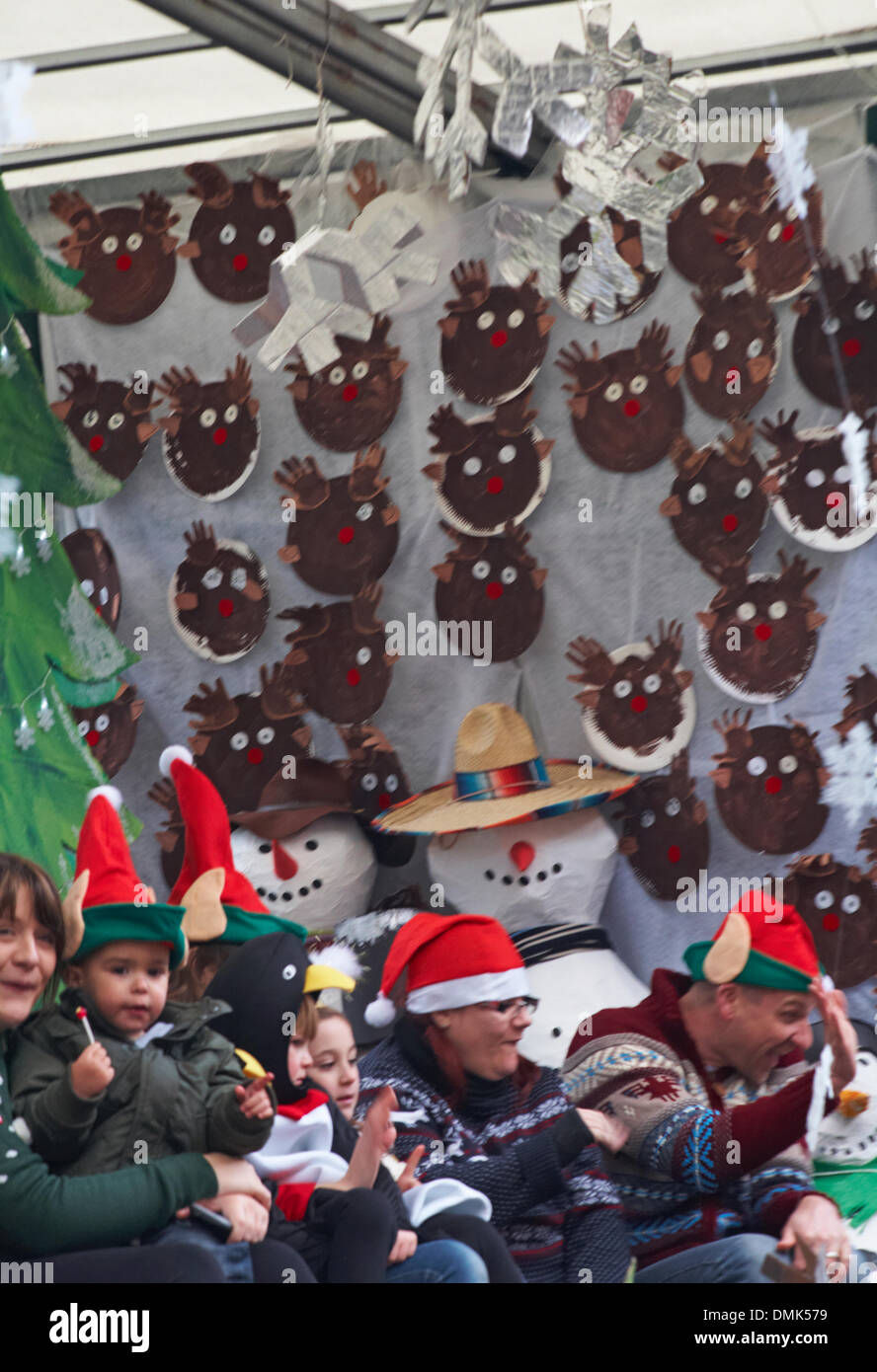 Wimborne, Dorset, UK. 14th December 2013. Crowds turn out to watch the 25th Wimborne Save The Children Christmas Parade. Children on float wearing Christmas Elf hats with snowmen and reindeer faces. Credit:  Carolyn Jenkins/Alamy Live News Stock Photo