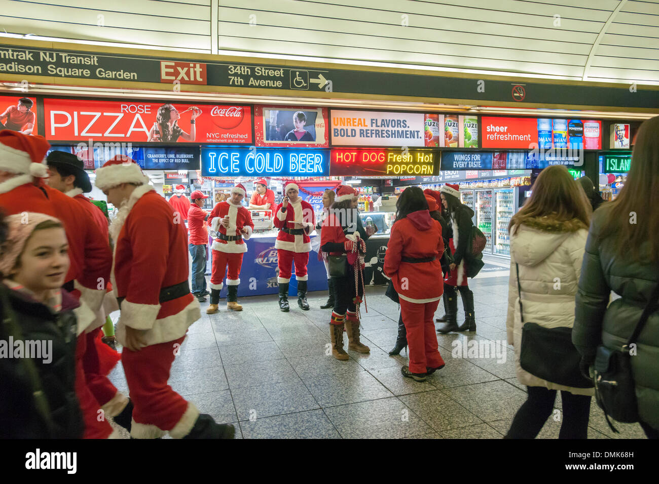 New York, USA. 14th December 2013. Christmas revelers arrive at Pennsylvania Station for the annual SantaCon in New York .  Santacon, primarily a pub crawl in Santa and other Christmas related costumes, attracts thousands of masqueraders going from bar to bar. The drinkers were encouraged to imbibe at establishments which are participating in Toys For Tots. This year some communities are complaining about vomiting, public urination and other misbehavior that accompanies the event resulting in a police and transit crackdown. Credit:  Richard Levine/Alamy Live News Stock Photo