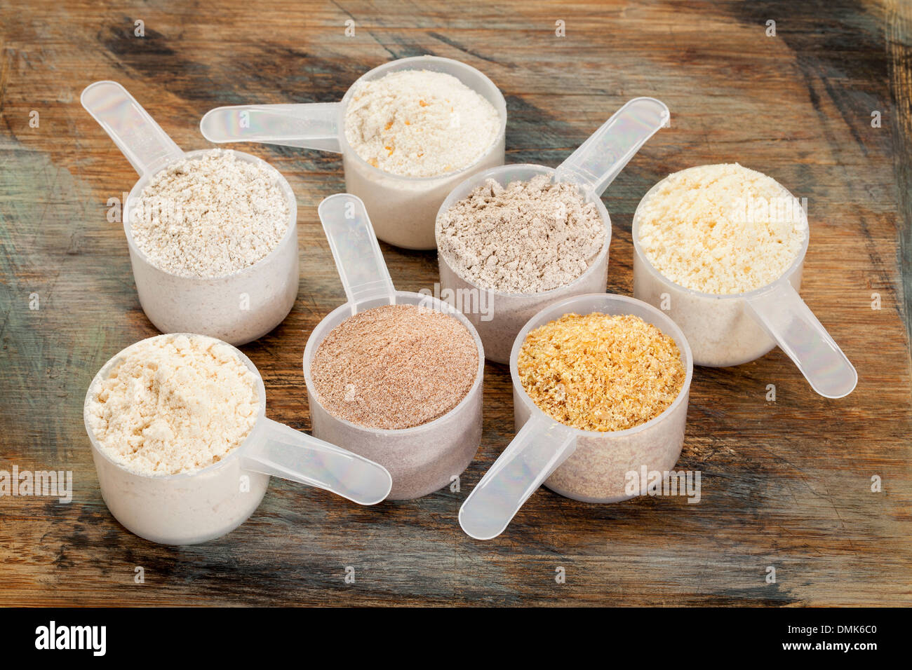 measuring scoops of gluten free flours - almond, coconut, teff, flaxseed meal, whole rice, brown rice, buckwheat Stock Photo