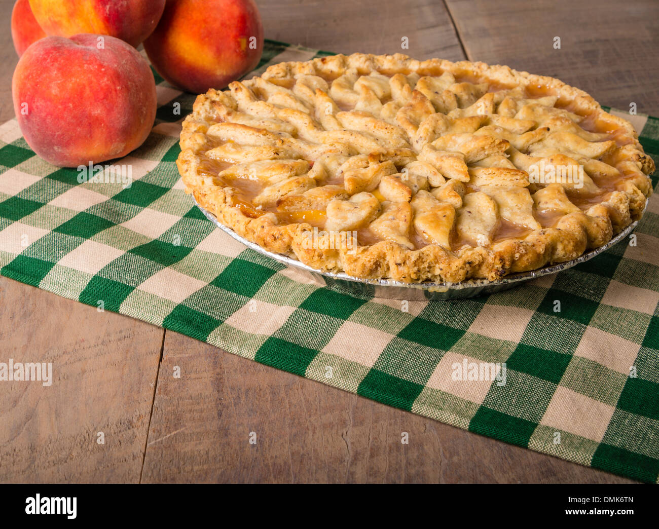 Peaches and peach pie with baked decorated crust Stock Photo Alamy