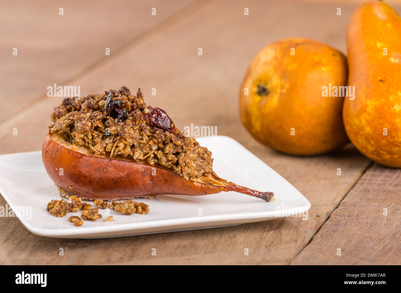 Baked bosc pear with cranberry crumble topping Stock Photo Alamy