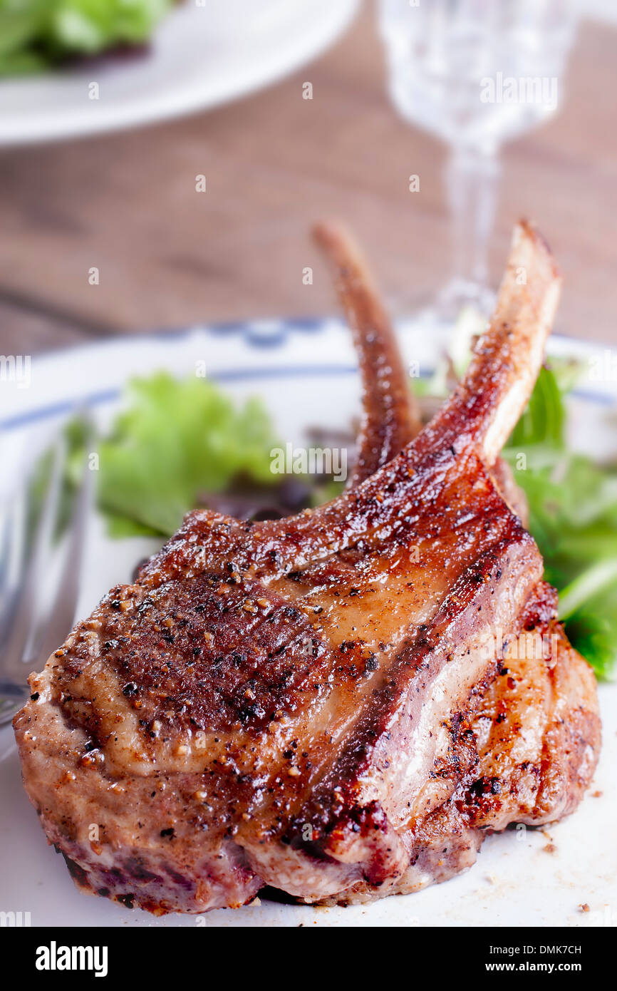 Lamb chop steak on white dish ready to serve Stock Photo Alamy