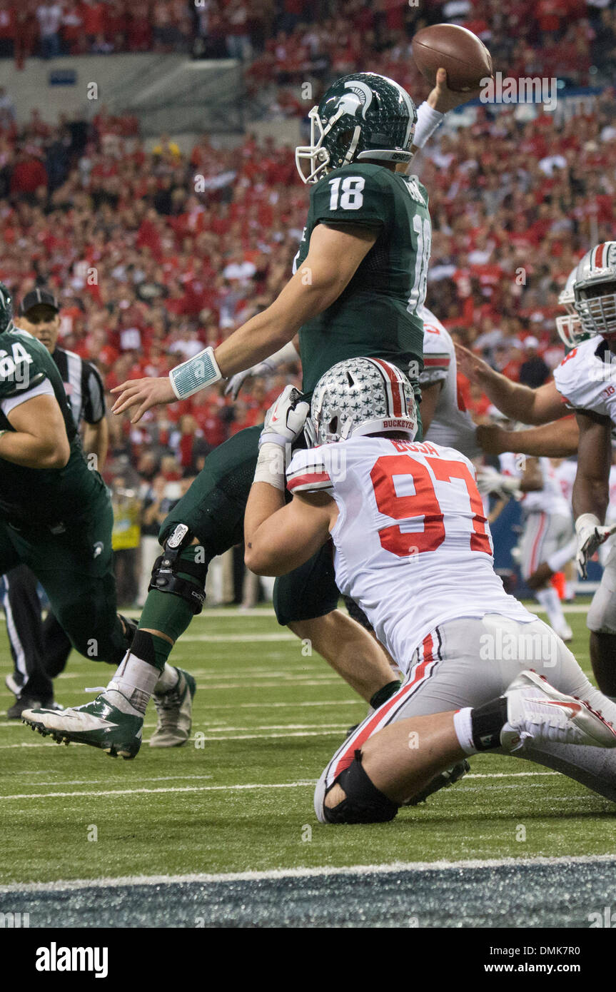 Indianapolis, IN, USA. 7th Dec, 2013. Ohio State Buckeyes defensive lineman Joey Bosa (97) can't get to Michigan State Spartans quarterback Connor Cook (18) before he gets a pass off during the Big Ten Championship football game between the Ohio State Buckeyes and the Michigan State Spartans at Lucas Oil Stadium. Michigan State beat Ohio State 34-24 and earned a trip to the Rose Bowl as the Big Ten Champions. © csm/Alamy Live News Stock Photo