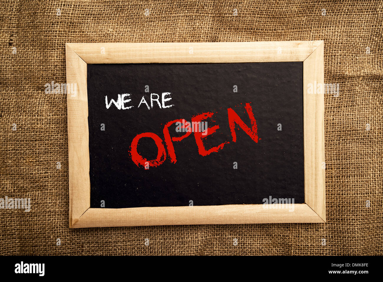 We are open note on black message board Stock Photo