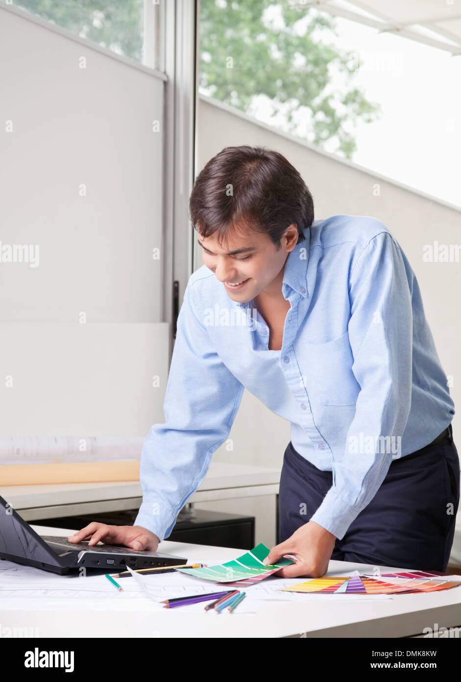 Male Interior Designer Using Laptop Stock Photo