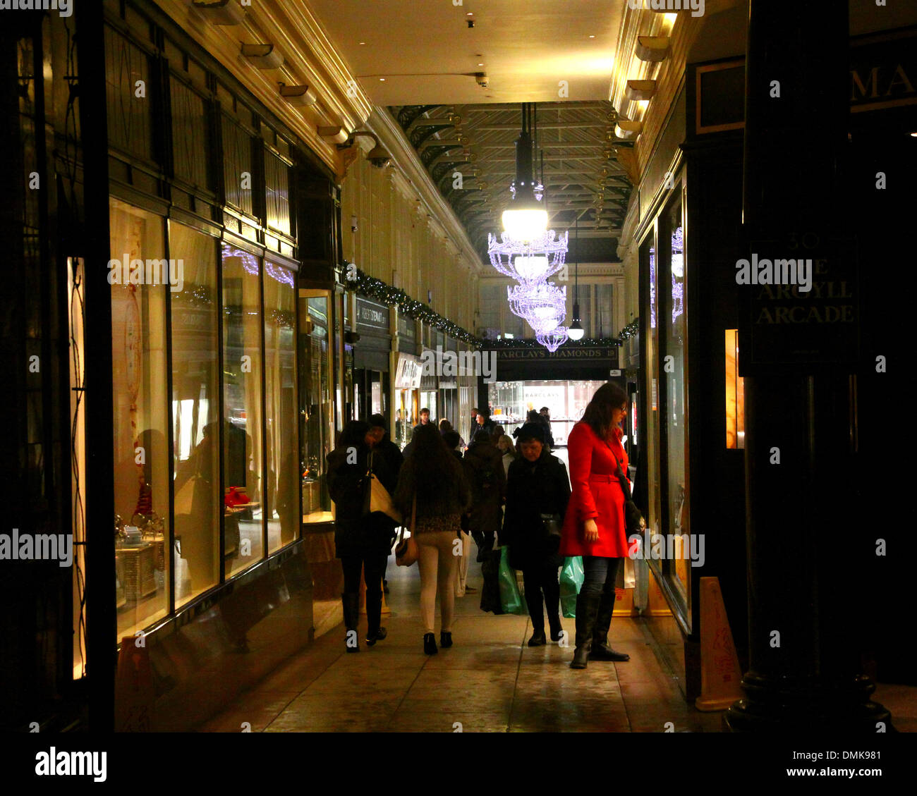 UK Weather 14 December.  Glasgow UK, Christmas shoppers sheltering from the rain and stormy winds in the Argyll Arcade. Stock Photo