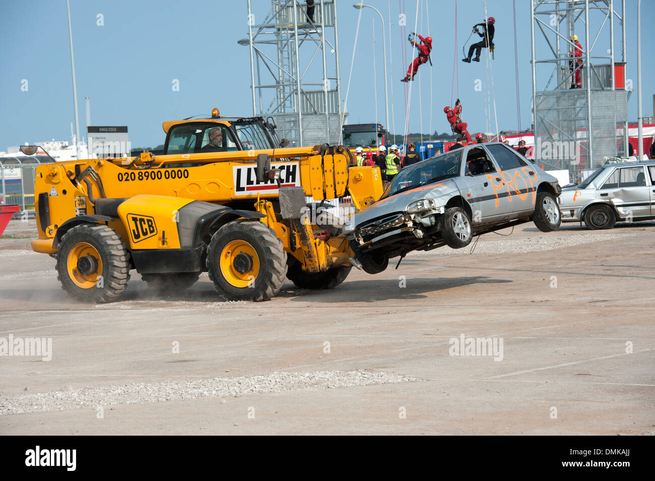 Scrap Car being moved by JCB Digger Stock Photo